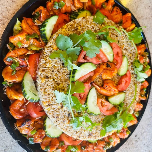 Vietnamese shrimp fried rice platter with tomatoes, cucumbers, and cilantro from vPho Westfield.