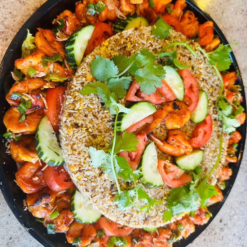 Vietnamese shrimp fried rice platter with tomatoes, cucumbers, and cilantro from vPho Westfield.